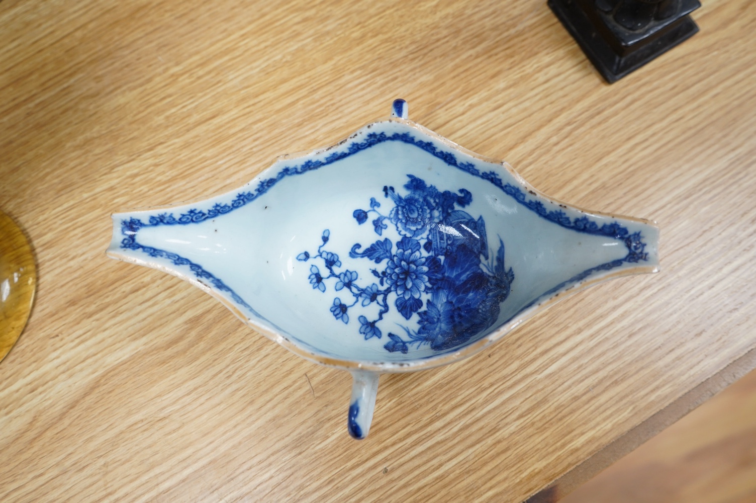 Three pieces of Chinese blue and white porcelain, including a double lipped sauceboat, 8.5cm high, and a famille rose lidded pot. Condition - fair